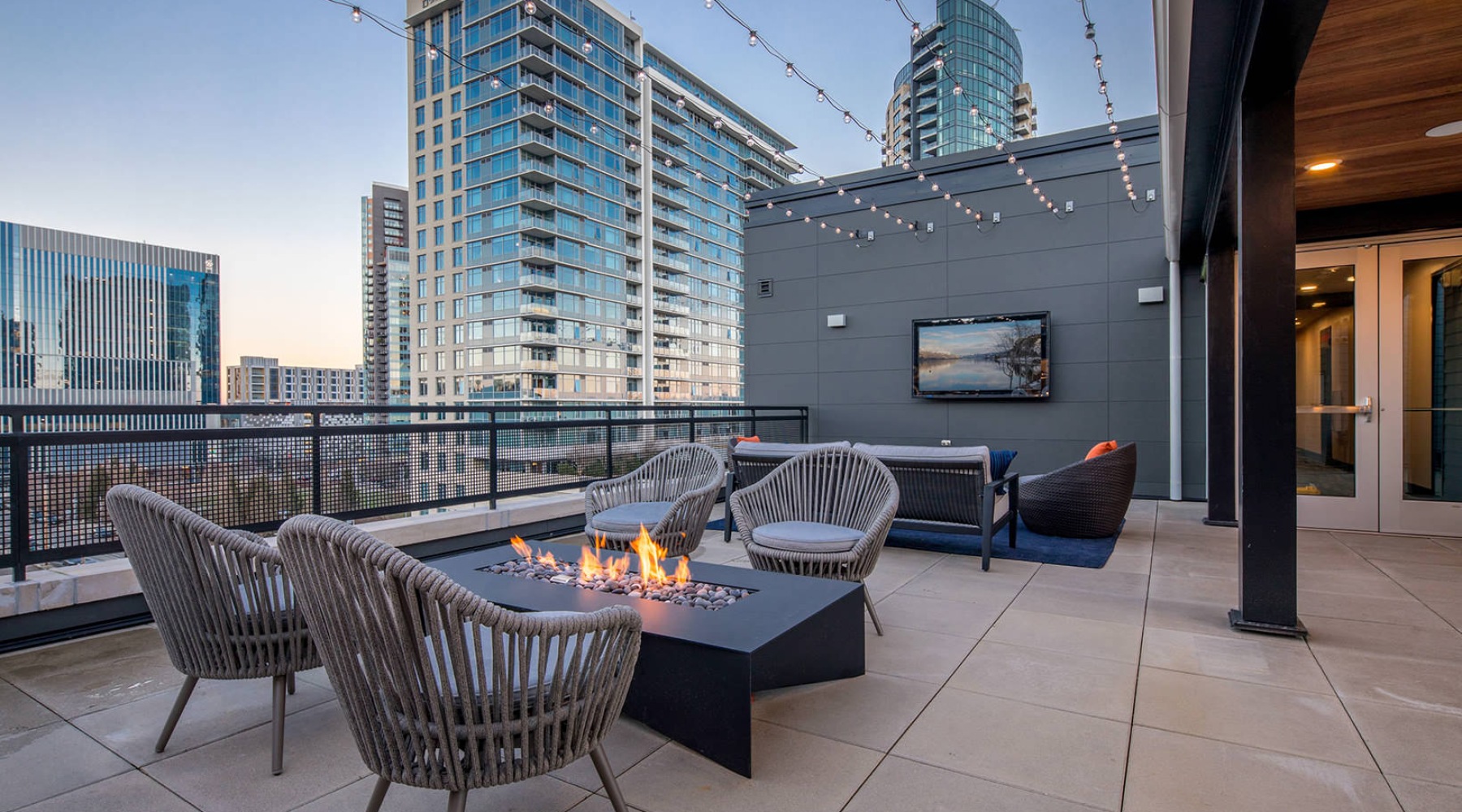 Upper Deck fire pit seating area and mounted tv viewing area on upper deck with neighborhood views