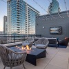 fire pit seating area and mounted tv viewing area on upper deck with neighborhood views