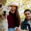 lifestyle image of a couple with a dog outdoors